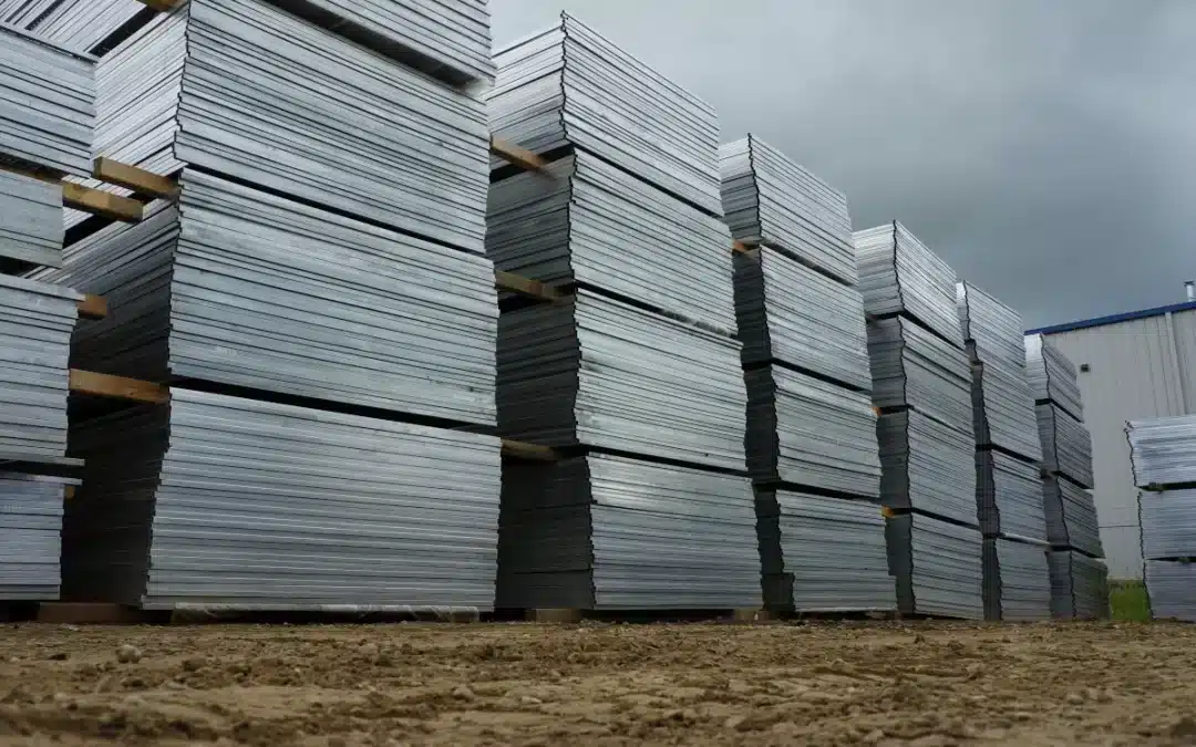 Tall stacks of construction fencing at FenceLine Rentals in Alberta.