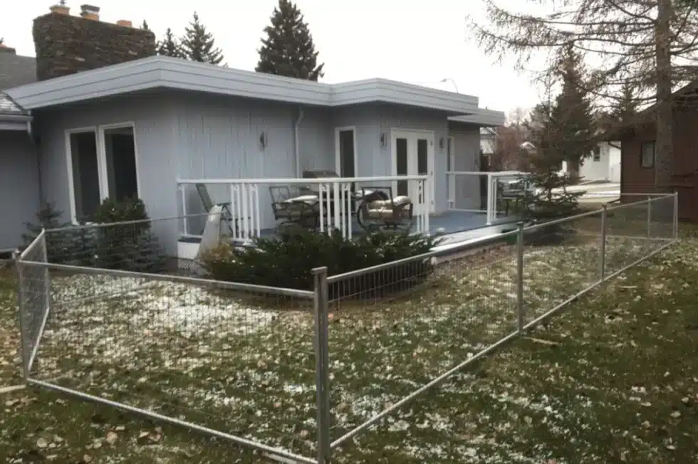 A Calgary house with a dog run in the yard