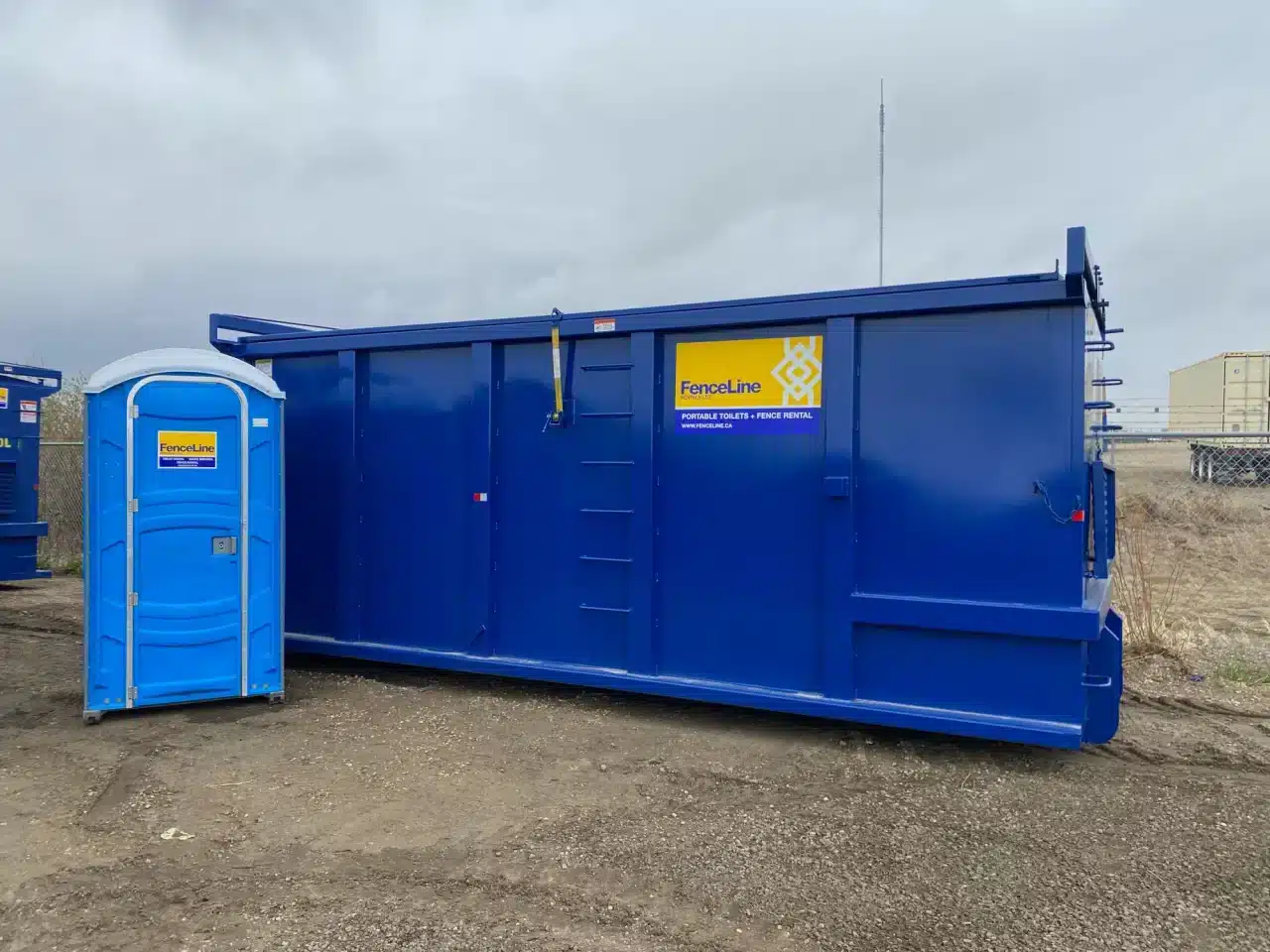 A waste bin and a porta potty at a construction site in Edmonton.