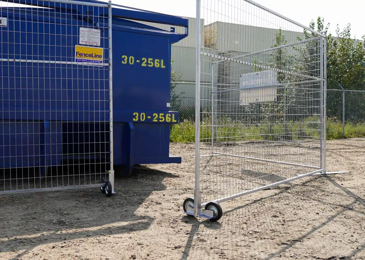 Temporary fencing for construction with a gate set up around a waste bin for easy access.