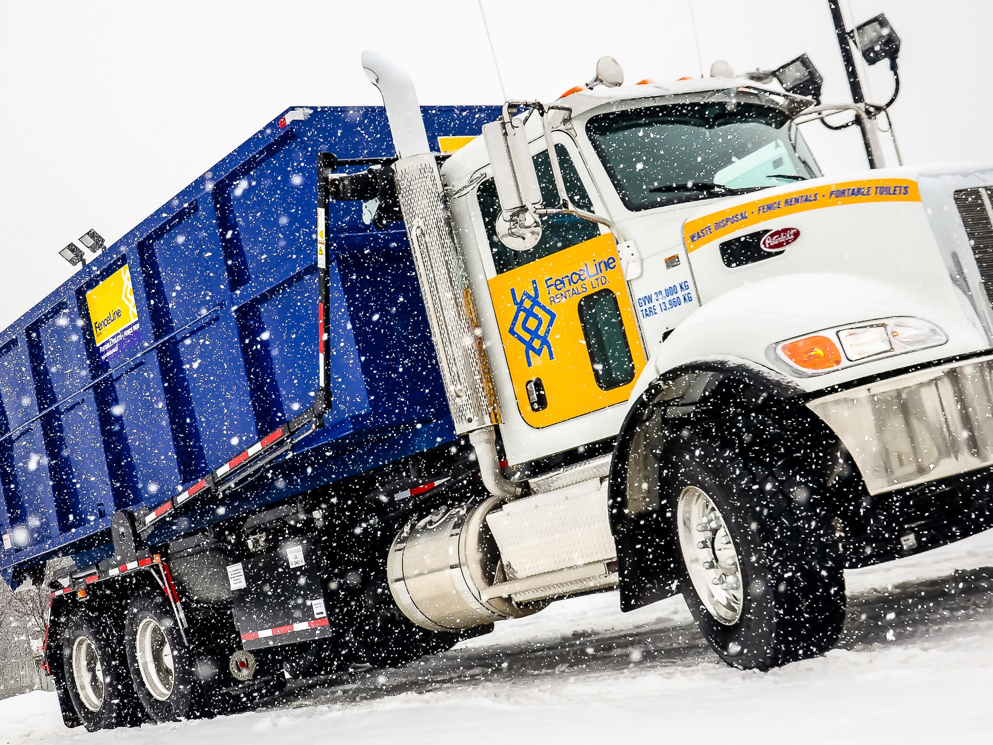 A FenceLine truck hauls waste away from a construction site in the winter in Alberta.