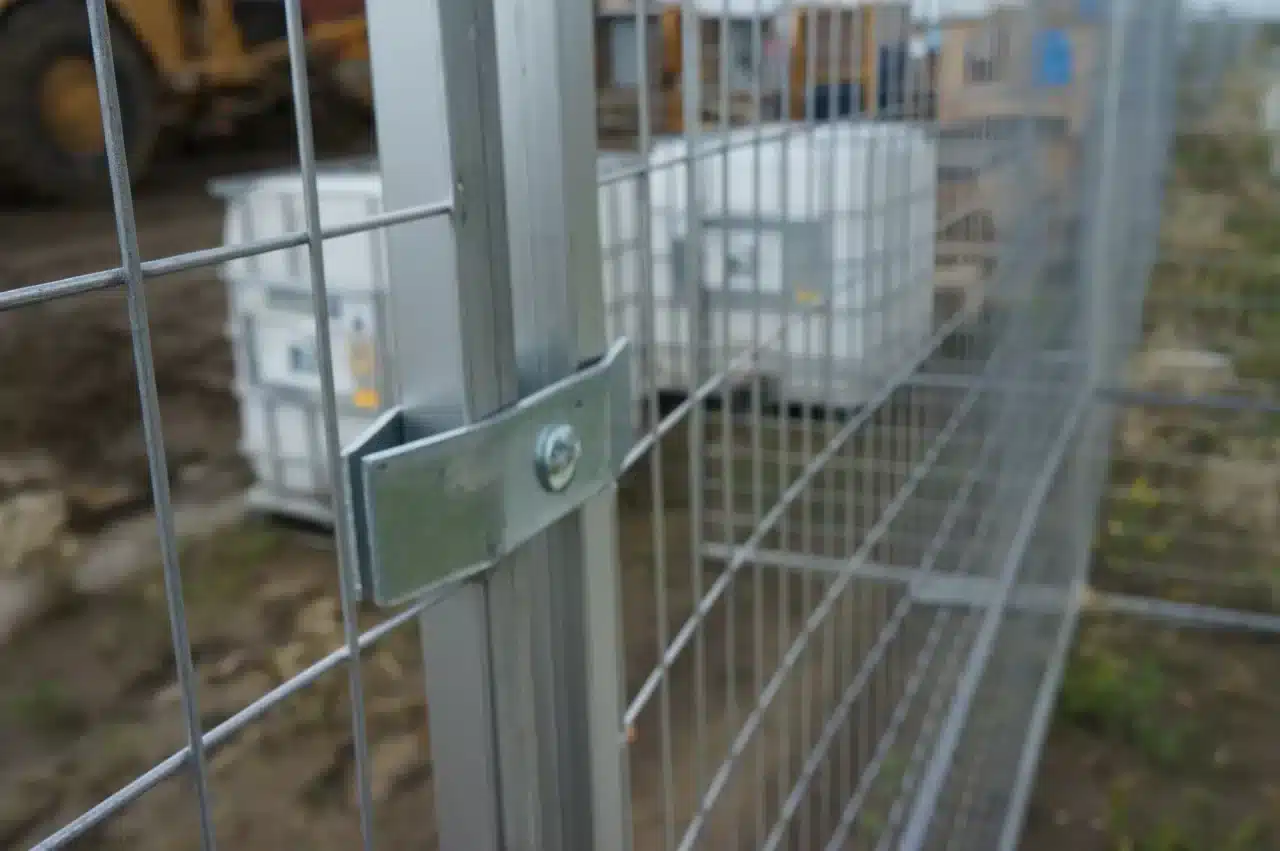 a close up of a temporary fence protecting the perimeter of an industrial site.