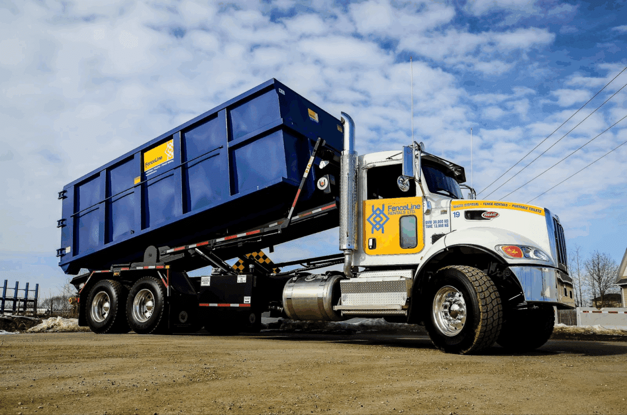 A FenceLine truck delivers a large waste bin to a site in Calgary.