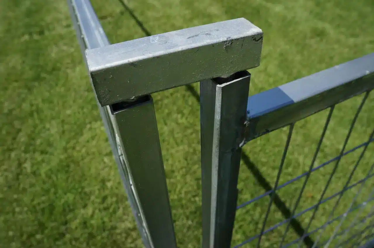 A coupler secures two panels to make a secure dog fence