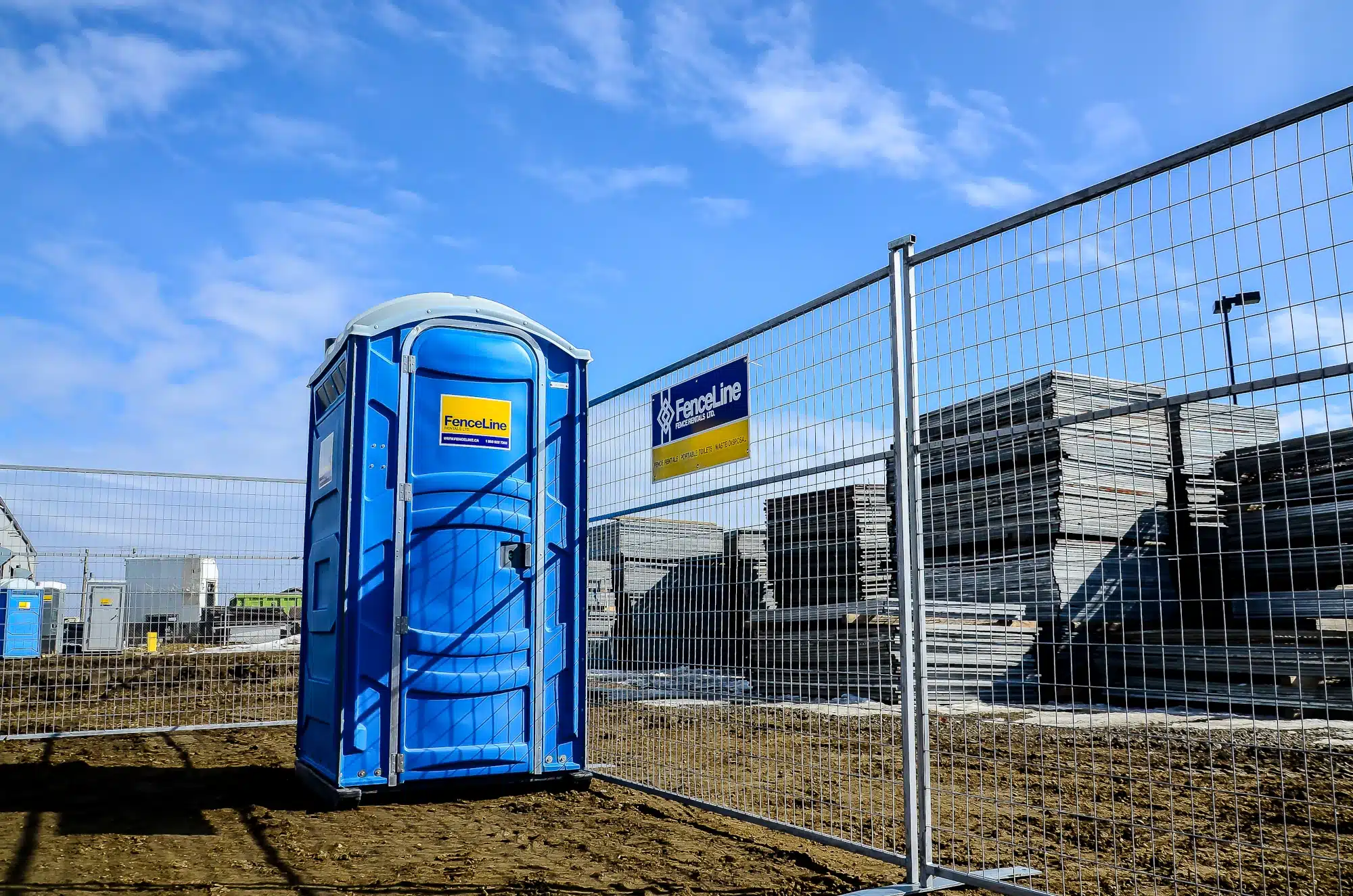 A row of portable toilets at an outdoor event in Edmonton.