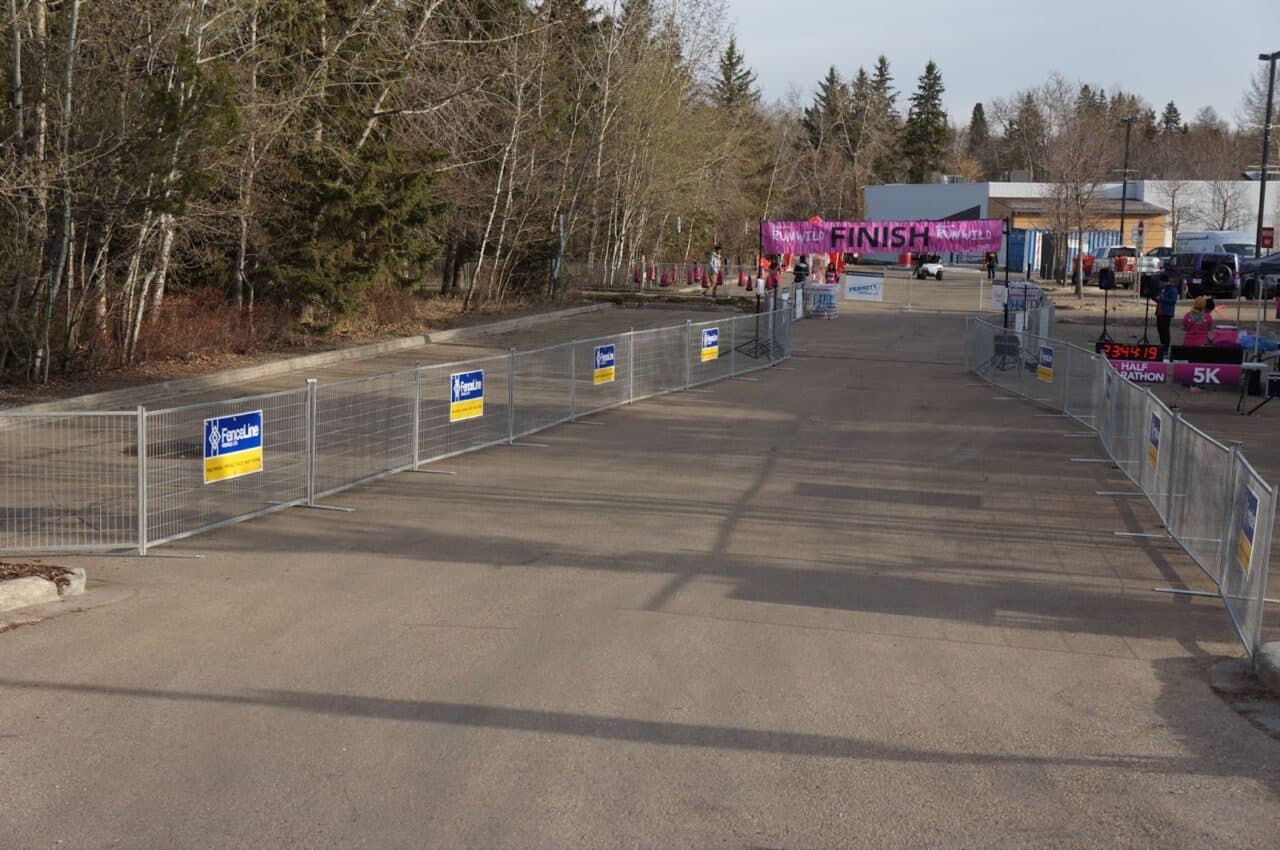 Temporary fencing forms a barrier separating runners from the crowd in Edmonton.