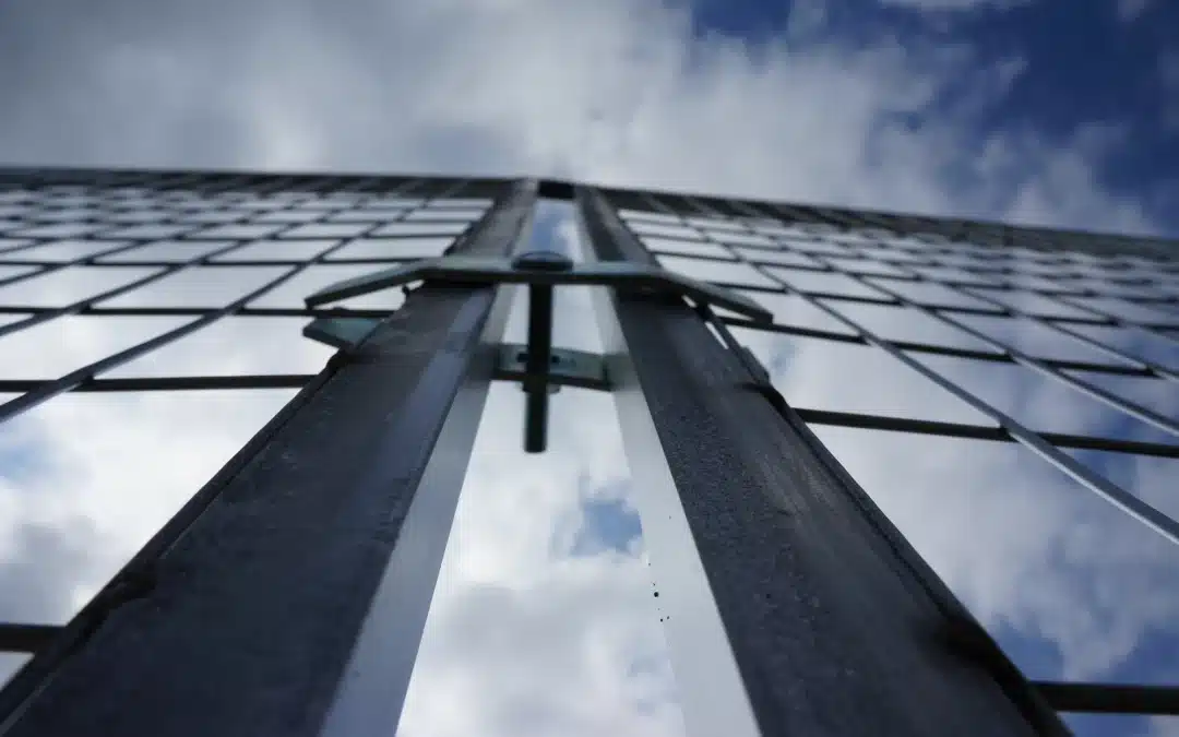 A close-up of two temporary fences secured with a super clamp in Alberta winter.