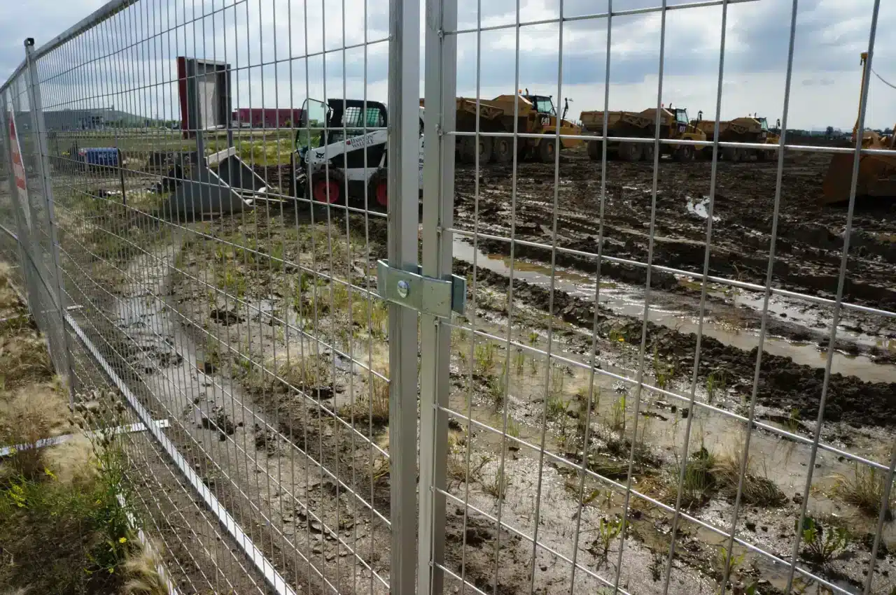 A secure fence surrounds a construction site in Alberta.