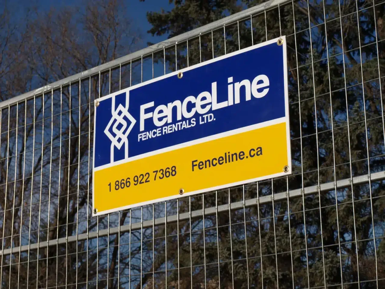 A FenceLine site on a temporary fence panel on a construction site in Calgary.