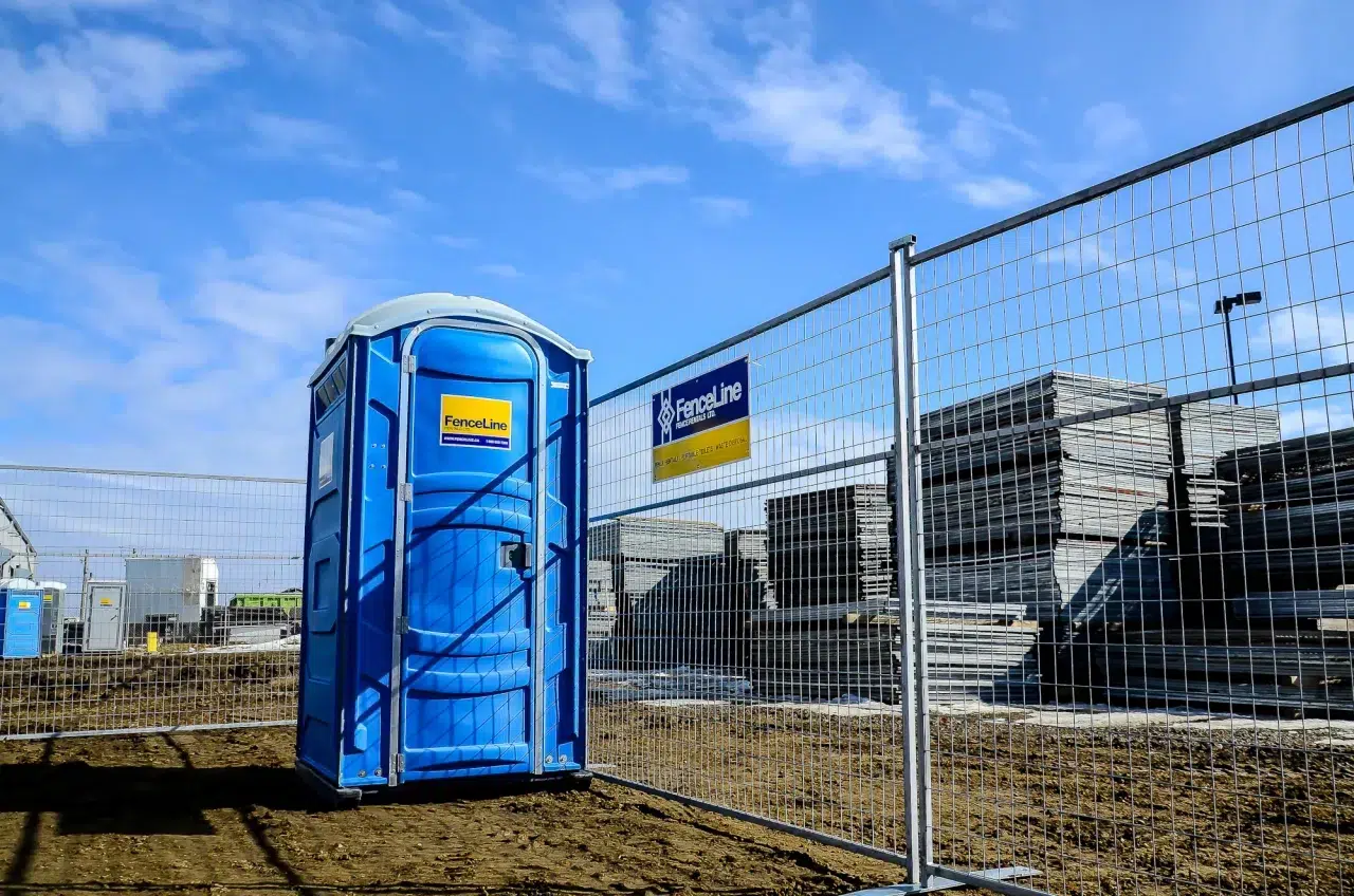 A standard duty fence secured with couplers and bases on an industrial site in Alberta.