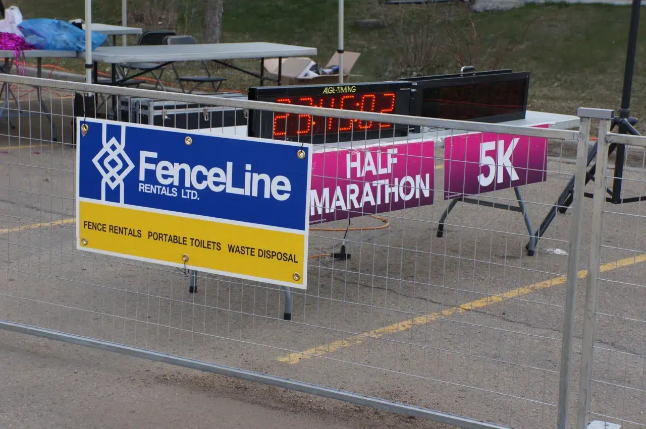 A temporary fence barrier at an outdoor fun run in Edmonton.
