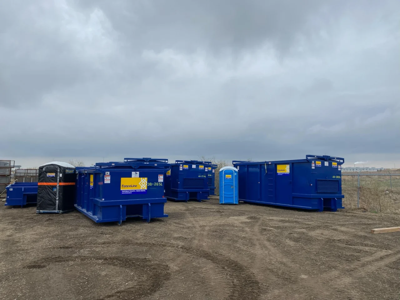Waste bins and porta potties sitting on a construction site near Calgary